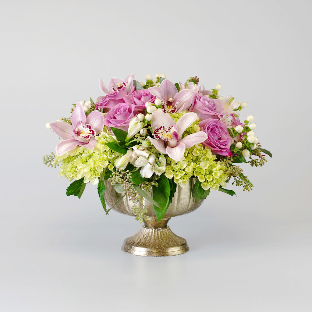 Soft Coloured arrangement in a gold footed container