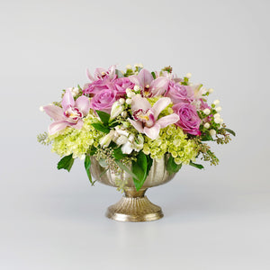 Soft Coloured arrangement in a gold footed container